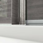 A detailed view of the glass panel with a sleek metal frame in a walk-in wetroom, designed for modern aesthetics. MLH Products.