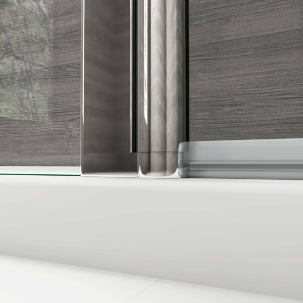 A detailed view of the glass panel with a sleek metal frame in a walk-in wetroom, designed for modern aesthetics. MLH Products.